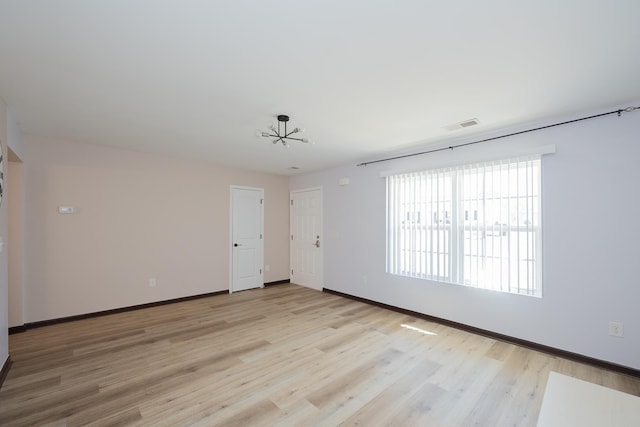 170 Old Timber, Woodruff, SC 29388 - empty room featuring light wood-style floors, baseboards, and a chandelier