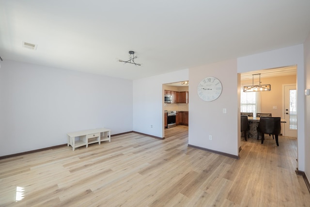 170 Old Timber, Woodruff, SC 29388 - unfurnished living room with light wood-style floors, a chandelier, and baseboards