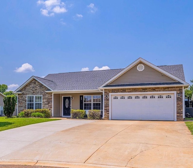 217 Legacy, Inman, SC 29349 - view of front facade with stone siding, concrete driveway, an attached garage, and a shingled roof