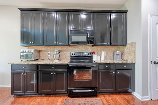 514 Millervale, Greer, SC 29650 - kitchen featuring black appliances, light wood finished floors, tasteful backsplash, baseboards, and light stone counters