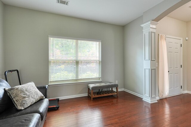 514 Millervale, Greer, SC 29650 - living area featuring arched walkways, hardwood / wood-style flooring, decorative columns, and plenty of natural light