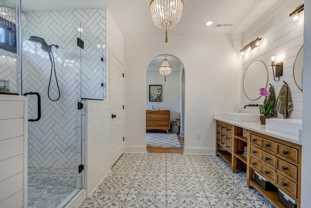 355 Night Lark, Campobello, SC 29322 - full bathroom featuring double vanity, a shower stall, a chandelier, baseboards, and recessed lighting