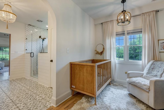 355 Night Lark, Campobello, SC 29322 - living area featuring a chandelier, healthy amount of natural light, arched walkways, and baseboards