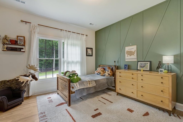 355 Night Lark, Campobello, SC 29322 - bedroom featuring multiple windows, wood finished floors, and a decorative wall