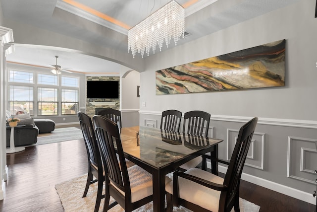 309 Old Kimbrell, Boiling Springs, SC 29316 - dining room with arched walkways, a fireplace, a ceiling fan, crown molding, and baseboards