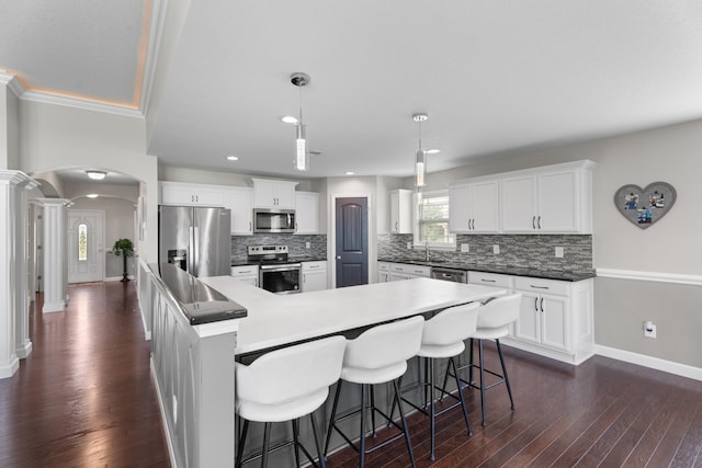 309 Old Kimbrell, Boiling Springs, SC 29316 - kitchen featuring stainless steel appliances, arched walkways, decorative columns, dark wood-style floors, and baseboards