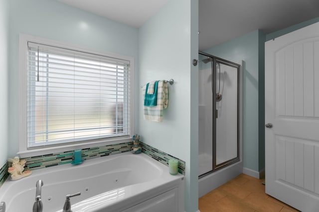 309 Old Kimbrell, Boiling Springs, SC 29316 - bathroom featuring a stall shower, a tub with jets, and plenty of natural light