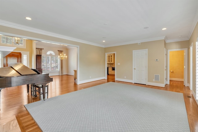 121 Commons, Spartanburg, SC 29302 - unfurnished living room featuring a chandelier, light wood-style floors, baseboards, crown molding, and recessed lighting