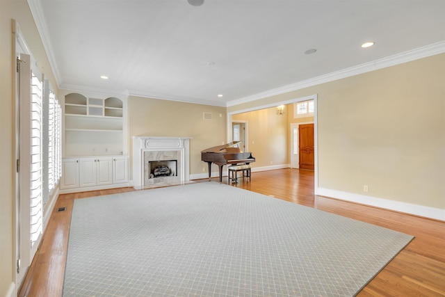 121 Commons, Spartanburg, SC 29302 - living room featuring light wood-style floors, crown molding, a premium fireplace, baseboards, and recessed lighting