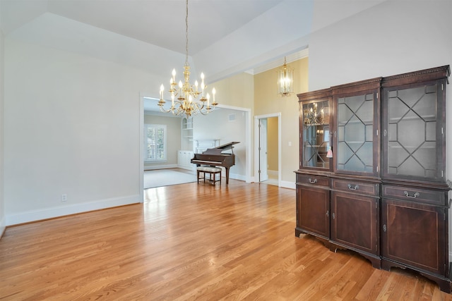 121 Commons, Spartanburg, SC 29302 - dining space featuring a chandelier, light wood-style flooring, baseboards, and a towering ceiling