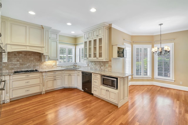 121 Commons, Spartanburg, SC 29302 - kitchen featuring dishwasher, cream cabinetry, stainless steel microwave, light wood-style floors, and gas cooktop