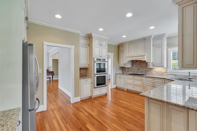 121 Commons, Spartanburg, SC 29302 - kitchen featuring stainless steel appliances, ornamental molding, tasteful backsplash, light wood-style floors, and a sink