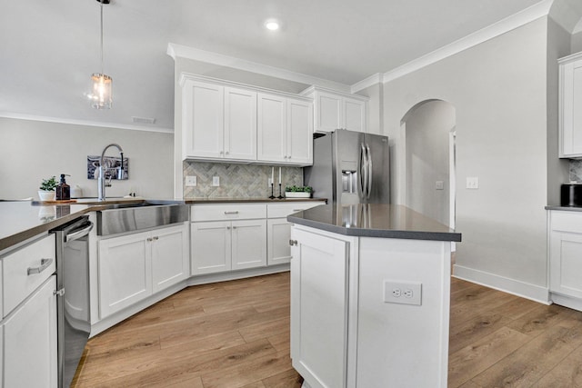 206 Hoss, Greenville, SC 29615 - kitchen with stainless steel appliances, ornamental molding, arched walkways, dark countertops, and decorative backsplash