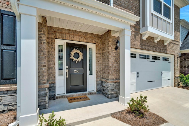 206 Hoss, Greenville, SC 29615 - view of exterior entry with a garage, stone siding, concrete driveway, and brick siding