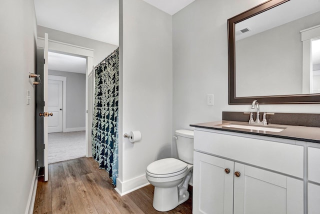 206 Hoss, Greenville, SC 29615 - full bath featuring wood finished floors, vanity, baseboards, toilet, and a shower with curtain