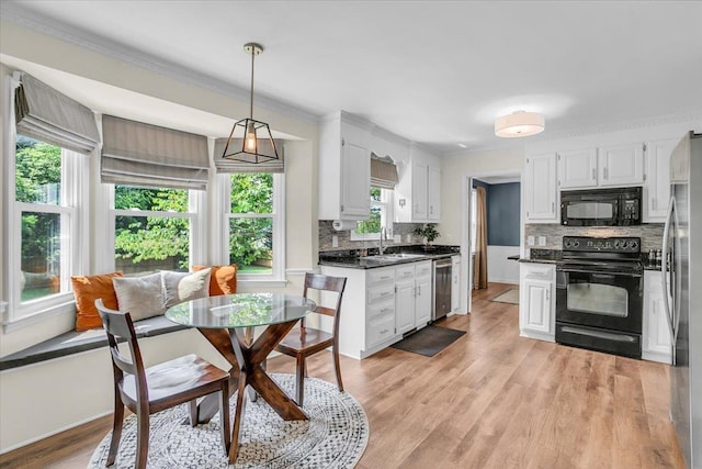 16 Chariot, Simpsonville, SC 29681 - kitchen with black appliances, dark countertops, backsplash, white cabinetry, and light wood-style floors