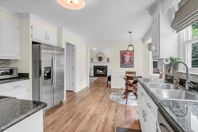 16 Chariot, Simpsonville, SC 29681 - kitchen with appliances with stainless steel finishes, a sink, a high end fireplace, light wood-style floors, and white cabinetry