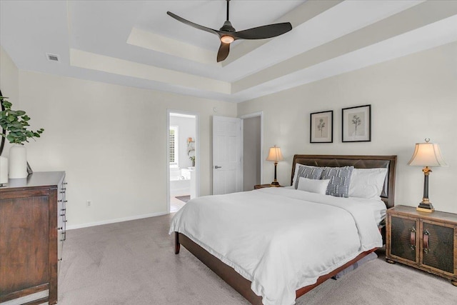16 Chariot, Simpsonville, SC 29681 - carpeted bedroom with a tray ceiling, baseboards, ceiling fan, and ensuite bath