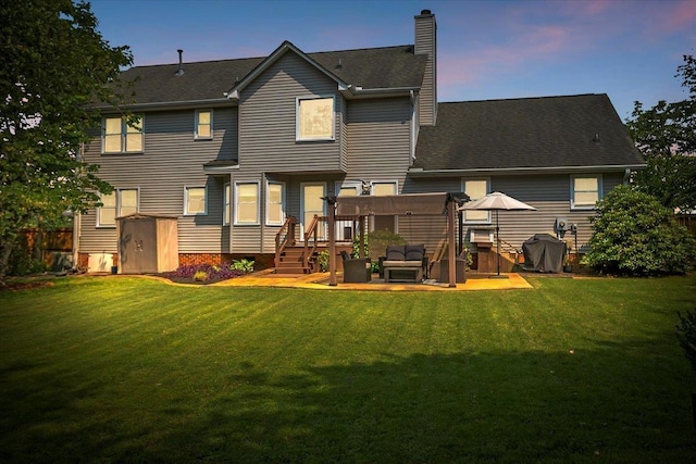 16 Chariot, Simpsonville, SC 29681 - back of property at dusk featuring a chimney and a wooden deck
