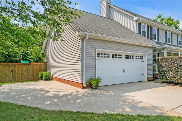 16 Chariot, Simpsonville, SC 29681 - view of property exterior featuring roof with shingles, driveway, a chimney, and a garage