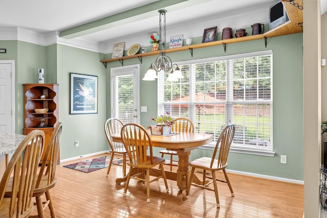 6533 NW Derby, Concord, NC 28027 - dining room featuring light wood-style floors, a chandelier, baseboards, and crown molding