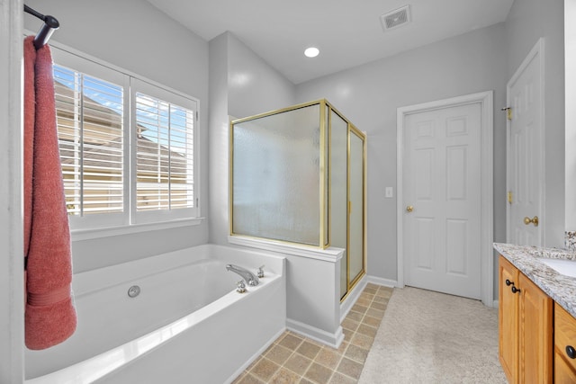 6533 NW Derby, Concord, NC 28027 - bathroom featuring a shower stall, a garden tub, vanity, and baseboards