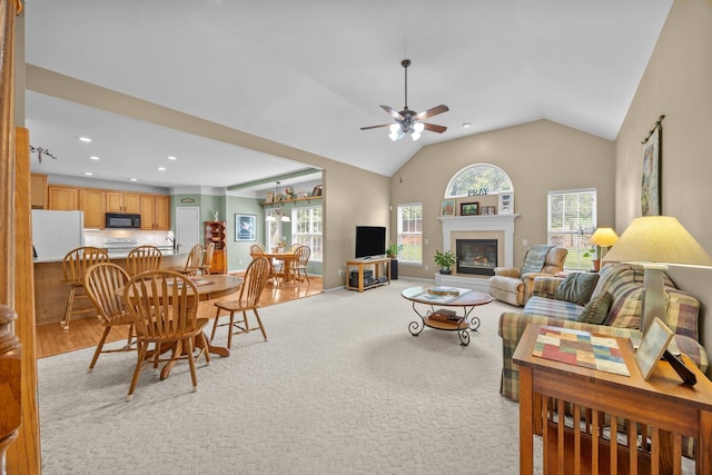 6533 NW Derby, Concord, NC 28027 - living area with a ceiling fan, a glass covered fireplace, lofted ceiling, recessed lighting, and light carpet