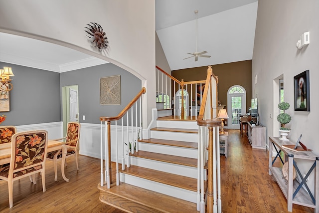 2030 Fasana, York, SC 29745 - stairway with high vaulted ceiling, wood finished floors, ceiling fan, a wainscoted wall, and arched walkways