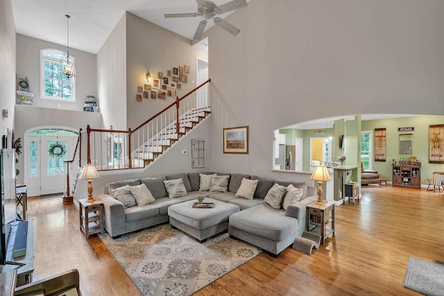 2030 Fasana, York, SC 29745 - living room featuring a towering ceiling, stairs, wood finished floors, a ceiling fan, and arched walkways