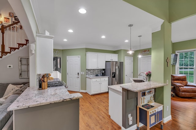 2030 Fasana, York, SC 29745 - kitchen with stainless steel fridge with ice dispenser, decorative backsplash, white cabinets, ornamental molding, and light stone countertops