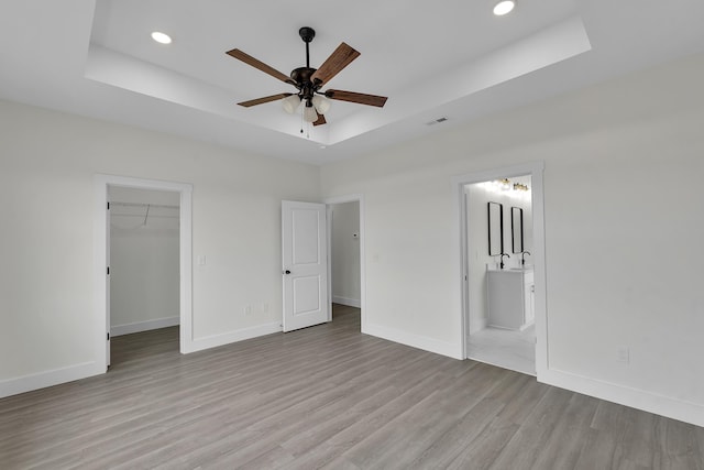 541 Bill Lattimore, Chesnee, SC 29323 - unfurnished bedroom with a tray ceiling, light wood-type flooring, recessed lighting, and baseboards