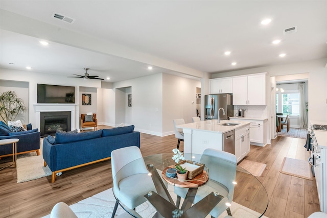 609 Cartmel, Greer, SC 29651 - dining area with light wood-style flooring, recessed lighting, baseboards, ceiling fan, and a glass covered fireplace