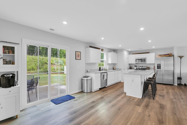 2097 Evanston, Wellford, SC 29385 - kitchen featuring stainless steel appliances, recessed lighting, a kitchen bar, a kitchen island, and white cabinetry