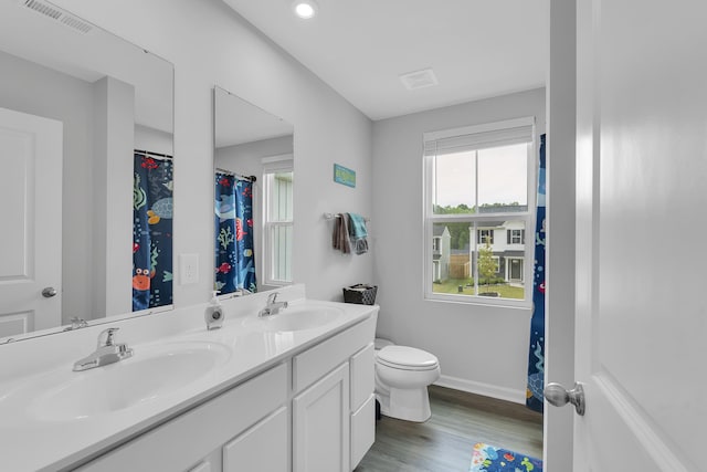 2097 Evanston, Wellford, SC 29385 - full bath with double vanity, wood finished floors, toilet, baseboards, and recessed lighting