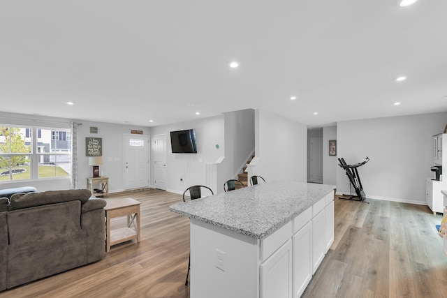 2097 Evanston, Wellford, SC 29385 - kitchen featuring recessed lighting, open floor plan, a kitchen island, white cabinets, and light wood-style floors