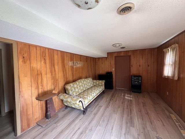 109 Berry, Boiling Springs, SC 29316 - sitting room featuring a textured ceiling, light wood finished floors, and wooden walls