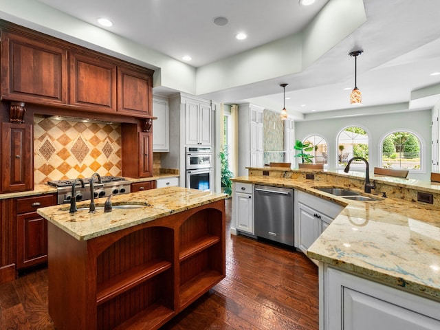 220 Fincher, Pauline, SC 29374 - kitchen with appliances with stainless steel finishes, a sink, a large island with sink, decorative backsplash, and dark wood-type flooring
