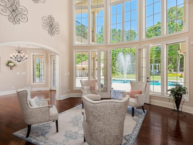 220 Fincher, Pauline, SC 29374 - living room with plenty of natural light, baseboards, wood finished floors, a towering ceiling, and arched walkways