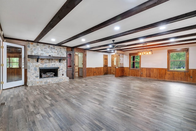 268 Margate, Chesnee, SC 29323 - unfurnished living room with wainscoting, wood finished floors, wood walls, beamed ceiling, and a fireplace