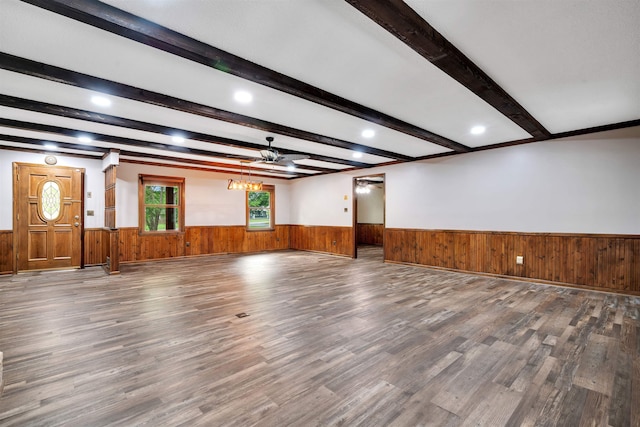 268 Margate, Chesnee, SC 29323 - unfurnished living room featuring wainscoting, wood finished floors, beamed ceiling, wooden walls, and a chandelier