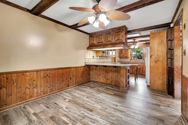 268 Margate, Chesnee, SC 29323 - kitchen featuring beam ceiling, a peninsula, a ceiling fan, wainscoting, and wood finished floors