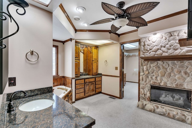 268 Margate, Chesnee, SC 29323 - bathroom with crown molding, two vanities, ceiling fan, a bath, and a fireplace