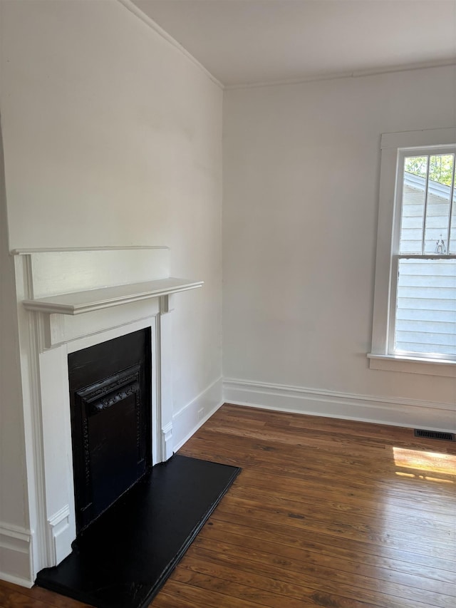 112 Scruggs, Spartanburg, SC 29303 - unfurnished living room with dark wood finished floors, a fireplace with raised hearth, and ornamental molding