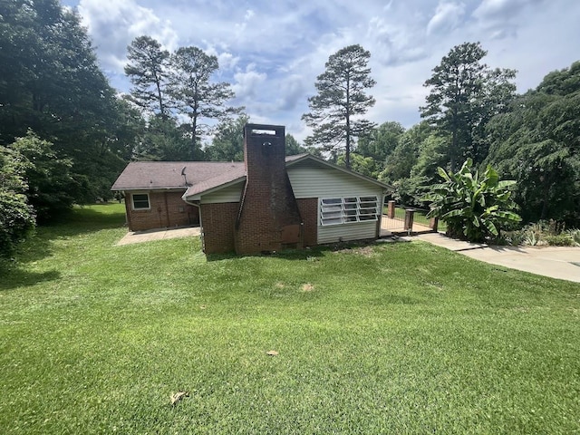 119 Hillside Dr, Gaffney, SC 29340 - rear view of house with brick siding, a yard, and a chimney