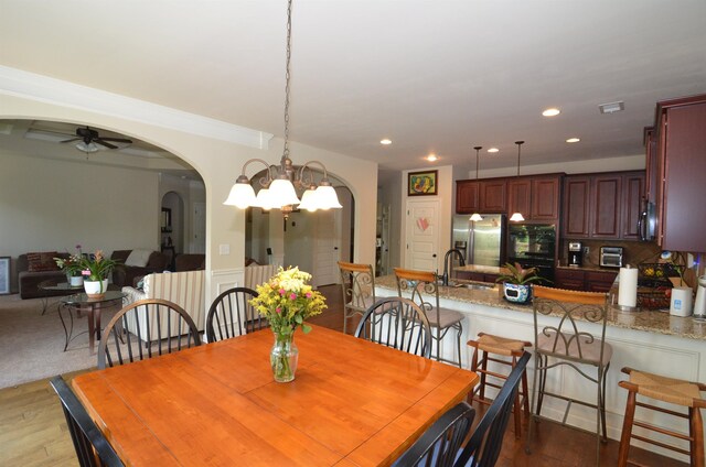 108 Dillard Crk, Greer, SC 29651 - dining space featuring arched walkways, a ceiling fan, dark wood-style floors, recessed lighting, and a chandelier