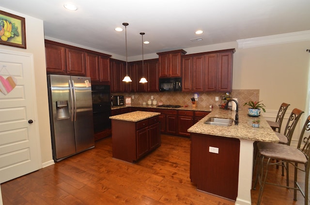108 Dillard Crk, Greer, SC 29651 - kitchen with black appliances, a peninsula, decorative backsplash, dark wood-style floors, and light stone countertops