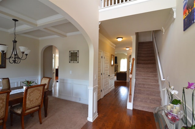 108 Dillard Crk, Greer, SC 29651 - dining room with crown molding, a chandelier, dark wood-type flooring, stairs, and arched walkways