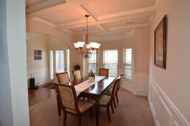 108 Dillard Crk, Greer, SC 29651 - dining room featuring a decorative wall, beamed ceiling, coffered ceiling, a chandelier, and arched walkways