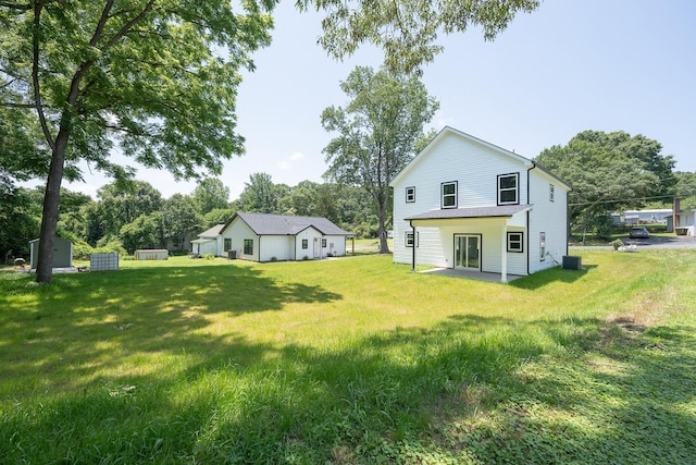 103 Cedar Fls, Fountain Inn, SC 29644 - back of property with a lawn, view of scattered trees, and a patio area