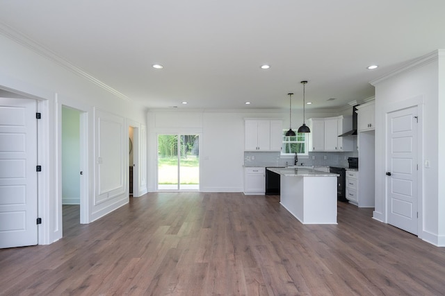 103 Cedar Fls, Fountain Inn, SC 29644 - kitchen featuring ornamental molding, healthy amount of natural light, wall chimney exhaust hood, open floor plan, and a center island